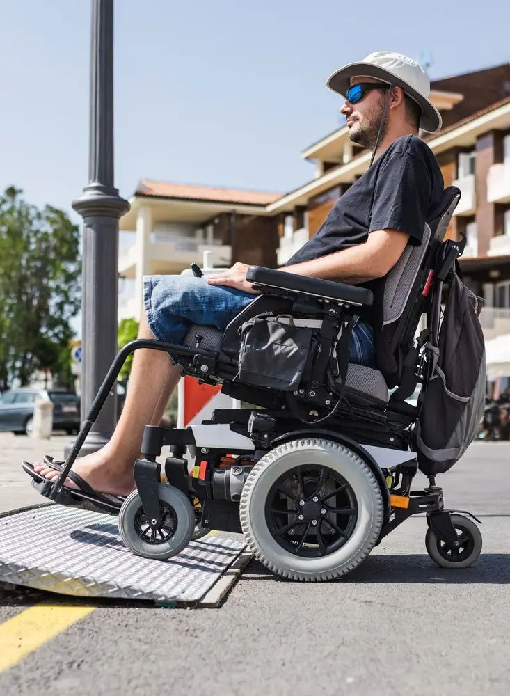 male-tourist-wheelchair-crossing-threshold-ramp-seaside-promenade-disability male tourist wheelchair crossing threshold ramp seaside promenade disability